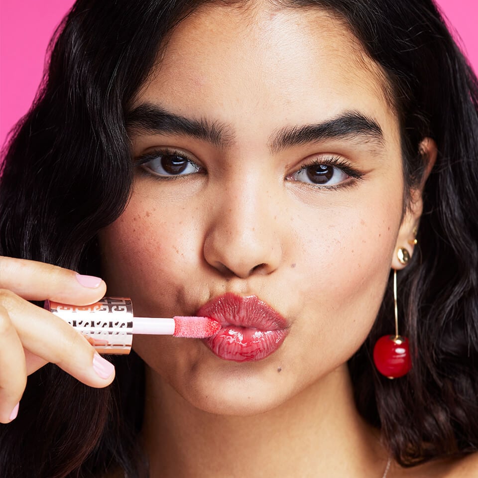 A Model wearing Revolution Pout Bomb Plumping Gloss