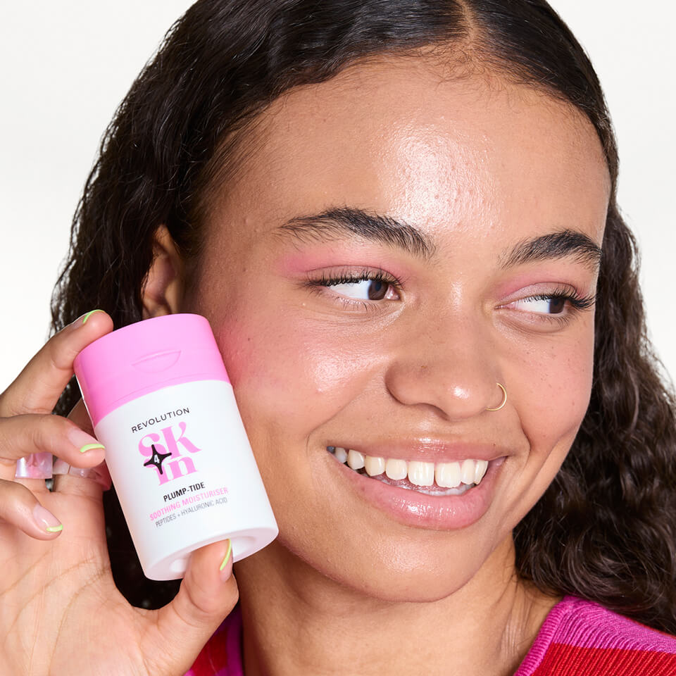 A photo of a girl holding Revolution moisturiser